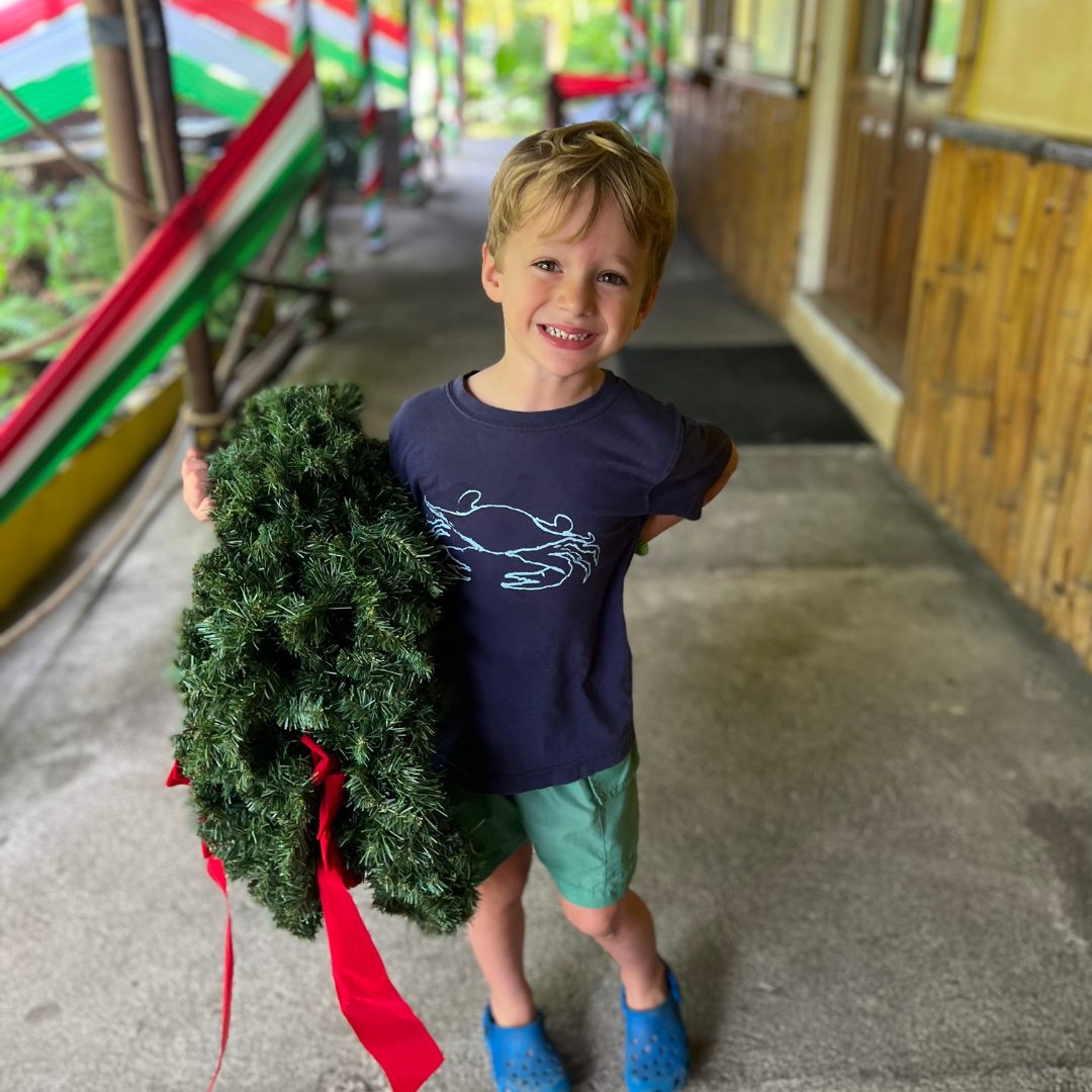 little boy helping with christmas decorations
